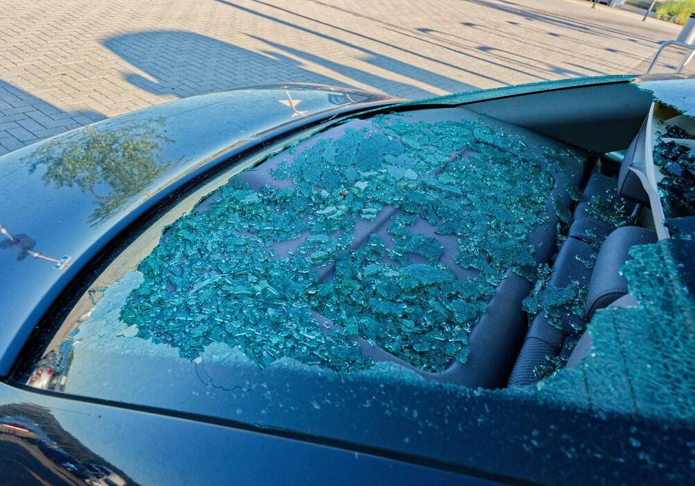shattered-rear-window-with-glass-scattered-inside-cabin-photo